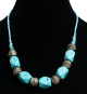 Collier ethnique artisanal imitation pierres bleues claires au losange agrementees de perles bleues et d'armatures argentees