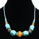 Collier ethnique artisanal imitation pierres bleues au losange agrementees d'armatures argentees, de perles bleues et d'une grosse pierre jaune