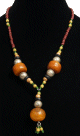 Collier ethnique artisanal imitation trois pieces spheriques en tagua agencees de perles multicolores