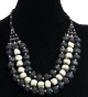Collier ethnique artisanal trois rangs imitation pierres noires et blanches agrementees de perles et d'armatures argentees