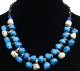 Collier ethnique artisanal imitation pierres bleues et blanches agencees de perles et agremente de pieces en metal argente